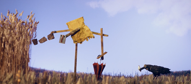 A still image from the film Au revoir Balthazar, showing a corn field from a low angle with unusual scarecrows in the foreground